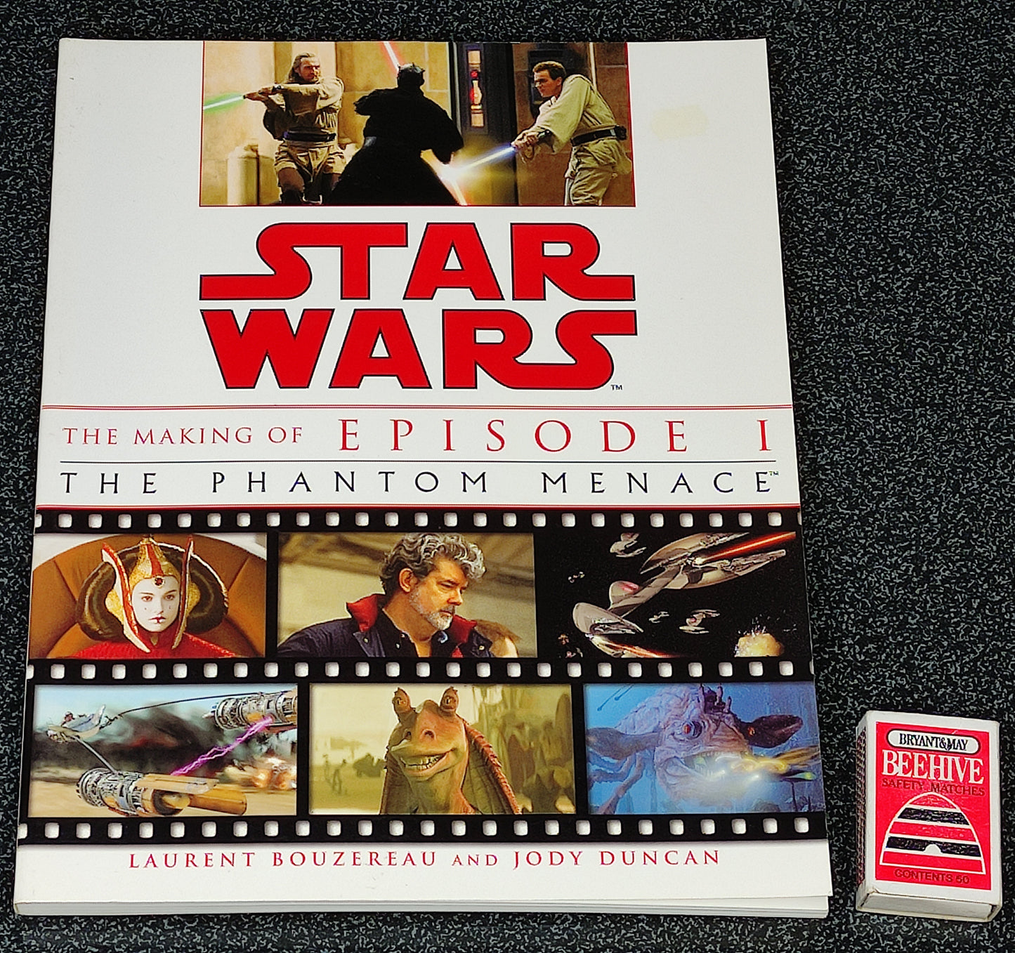 Book titled 'Star Wars: The Making of Episode I The Phantom Menace' on a dark textured surface.