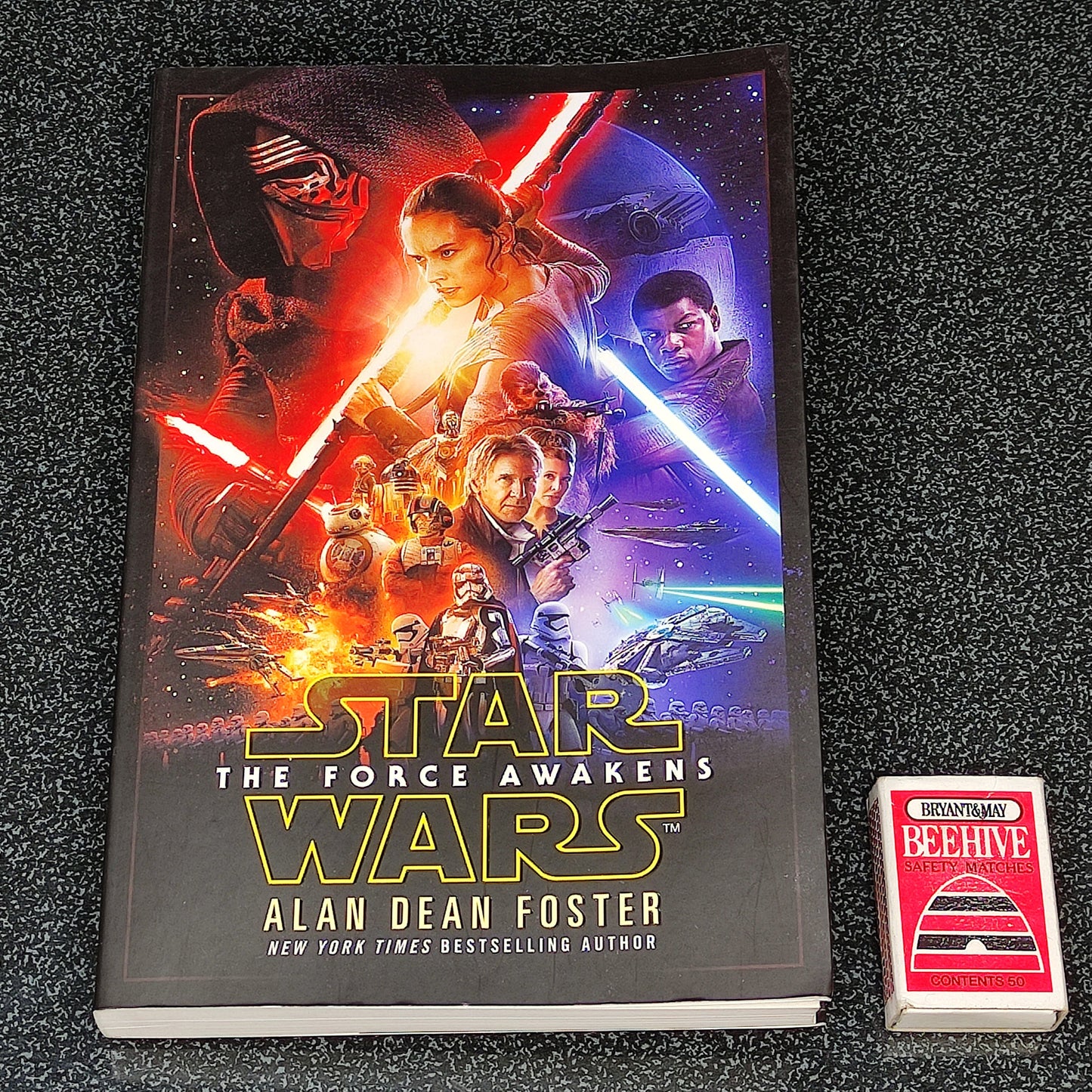 Book titled 'Star Wars: The Force Awakens' by Alan Dean Foster on a dark textured surface
