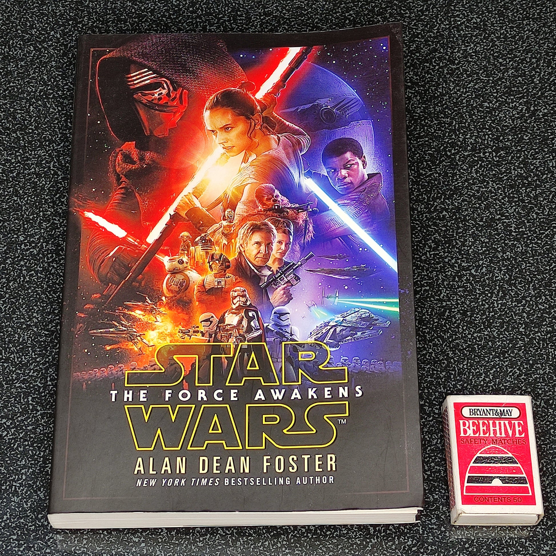 Book titled 'Star Wars: The Force Awakens' by Alan Dean Foster on a dark textured surface