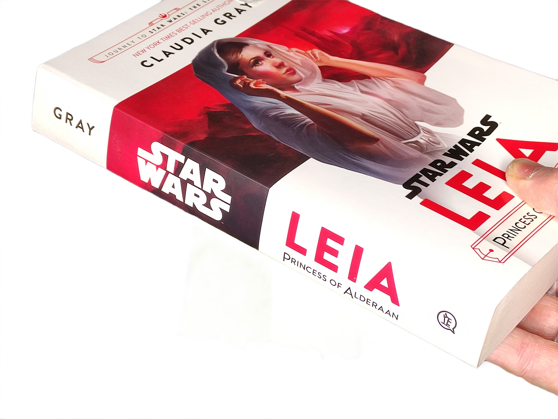 Book titled 'Star Wars: Leia' by Claudia Gray with a hand holding it.