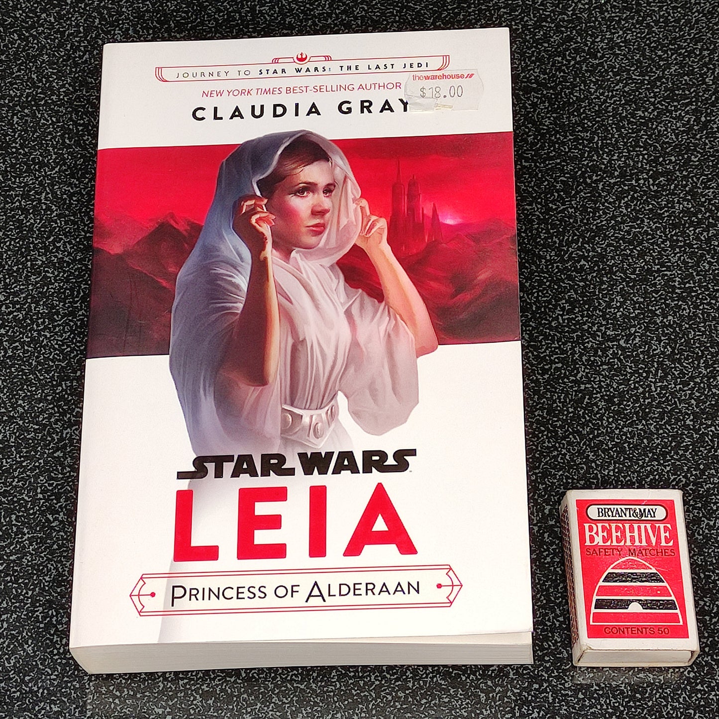 Book titled 'Star Wars: Leia Princess of Alderaan' by Claudia Gray on a dark textured surface