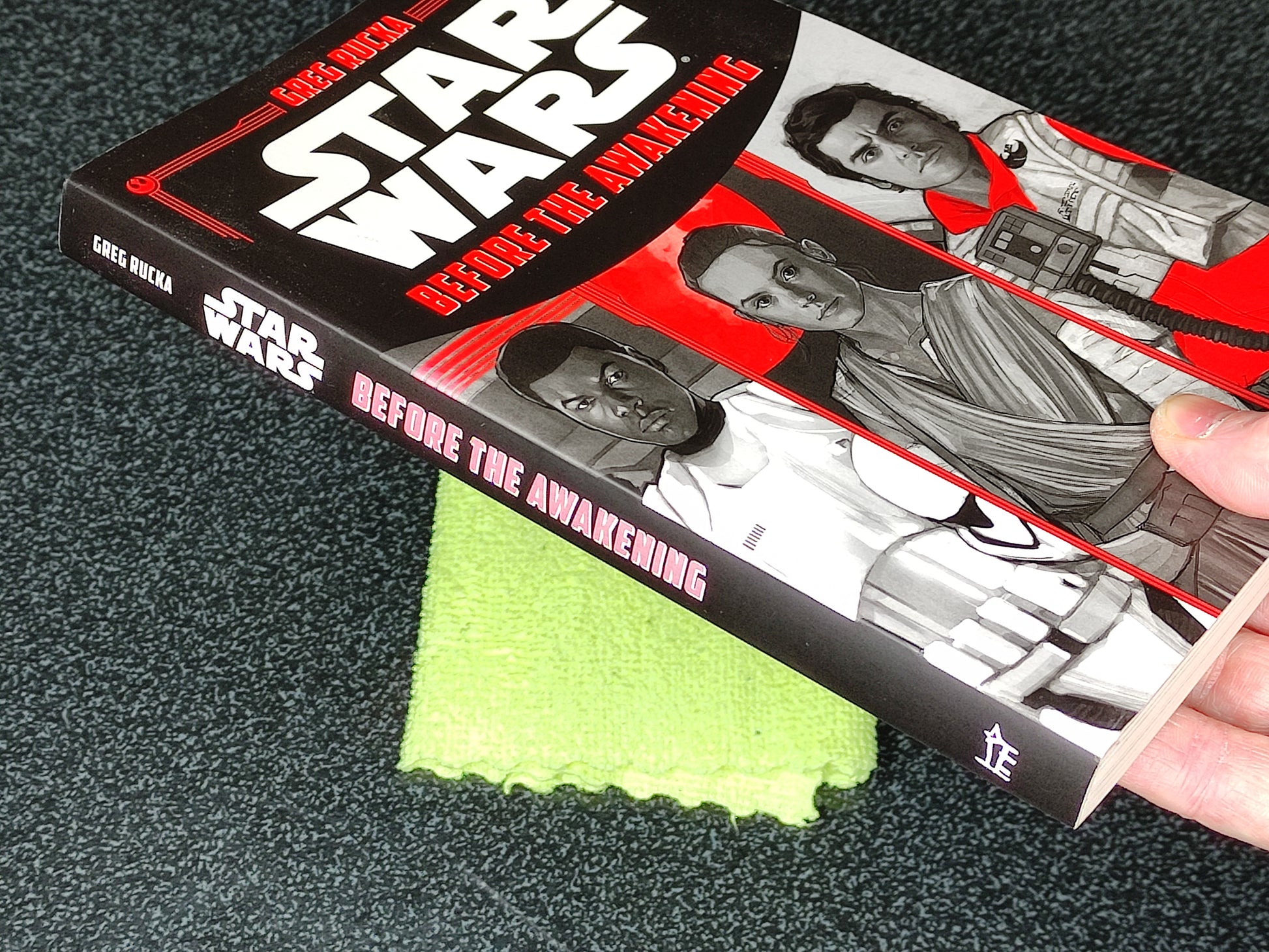 Star Wars book titled 'Before the Awakening' on a dark surface with a green cloth underneath.