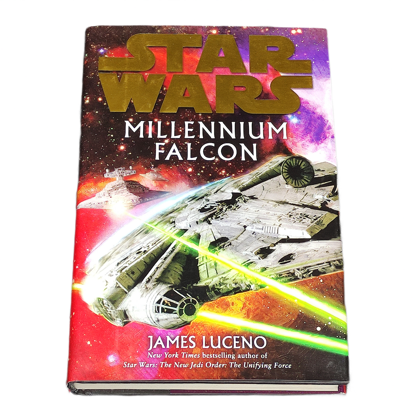 Book titled 'Millennium Falcon' by James Luceno with a spaceship illustration on a colourful background.