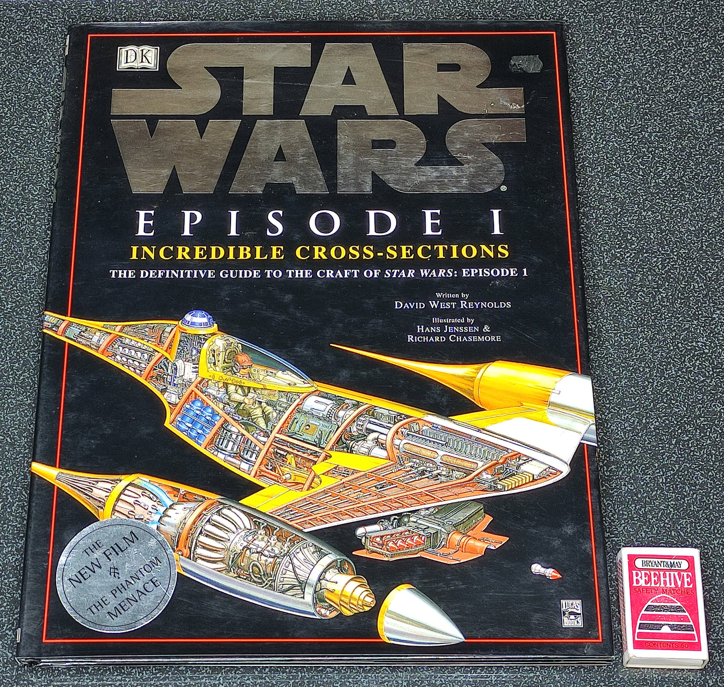 Book titled 'Star Wars Episode I: Incredible Cross-Sections' on a dark surface