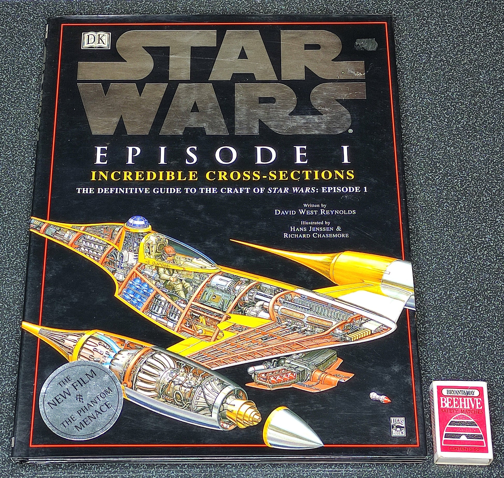 Book titled 'Star Wars Episode I: Incredible Cross-Sections' on a dark surface