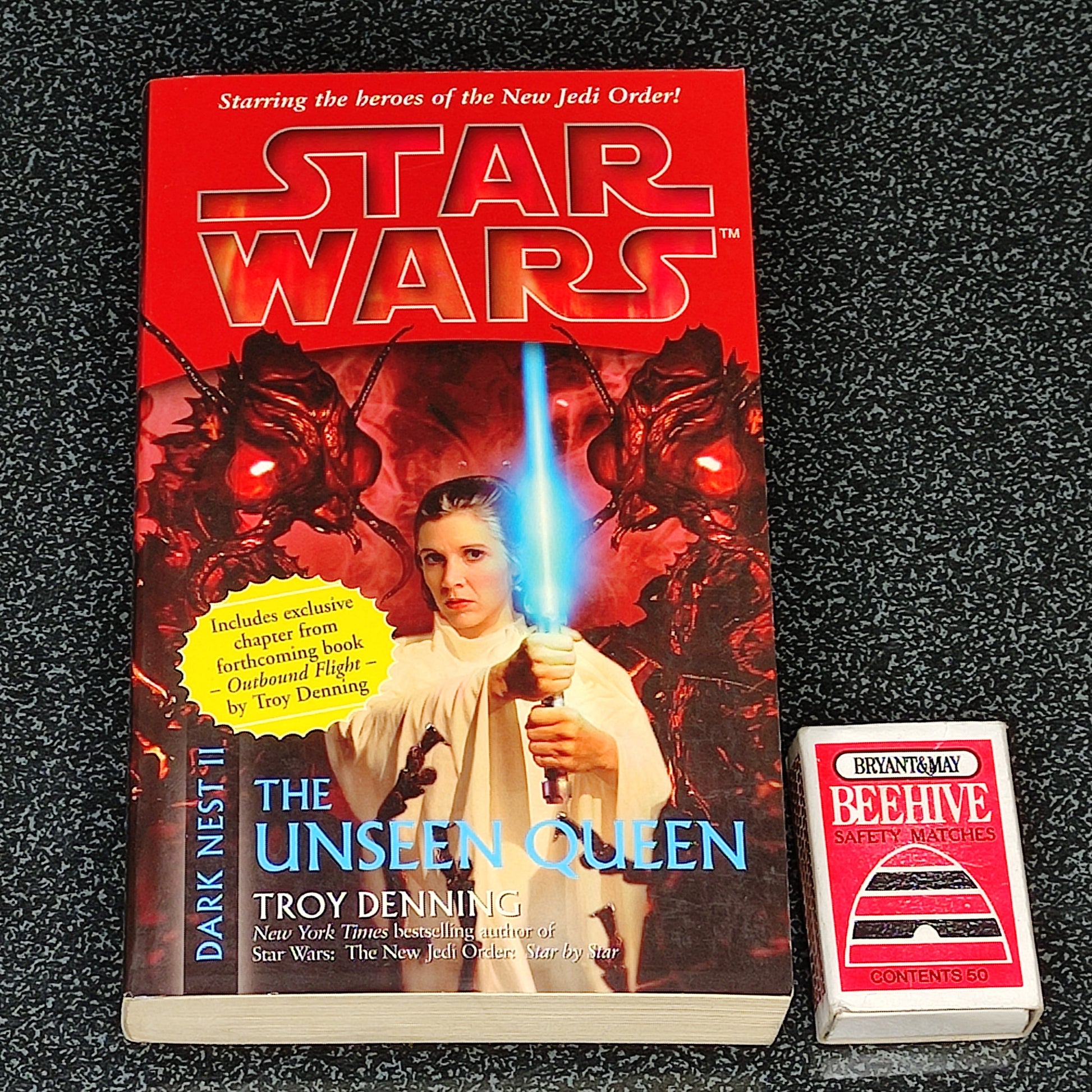 Star Wars book titled 'The Unseen Queen' by Troy Denning on a dark textured surface