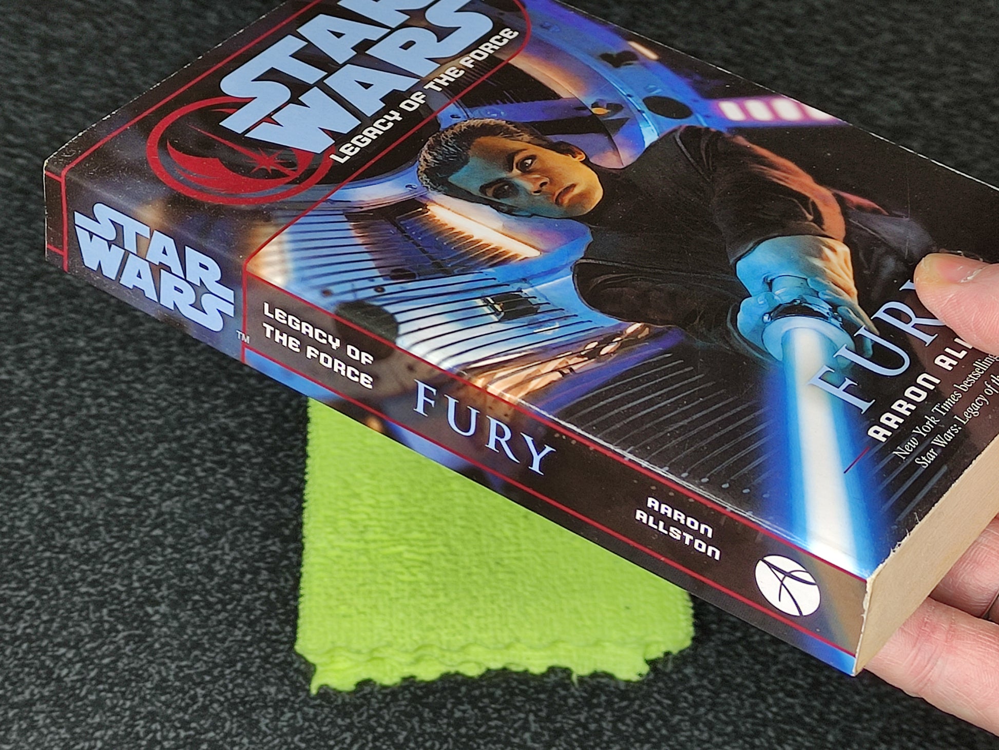 Book titled 'Fury' from 'Star Wars: Legacy of the Force' series on a dark surface with a green cloth.