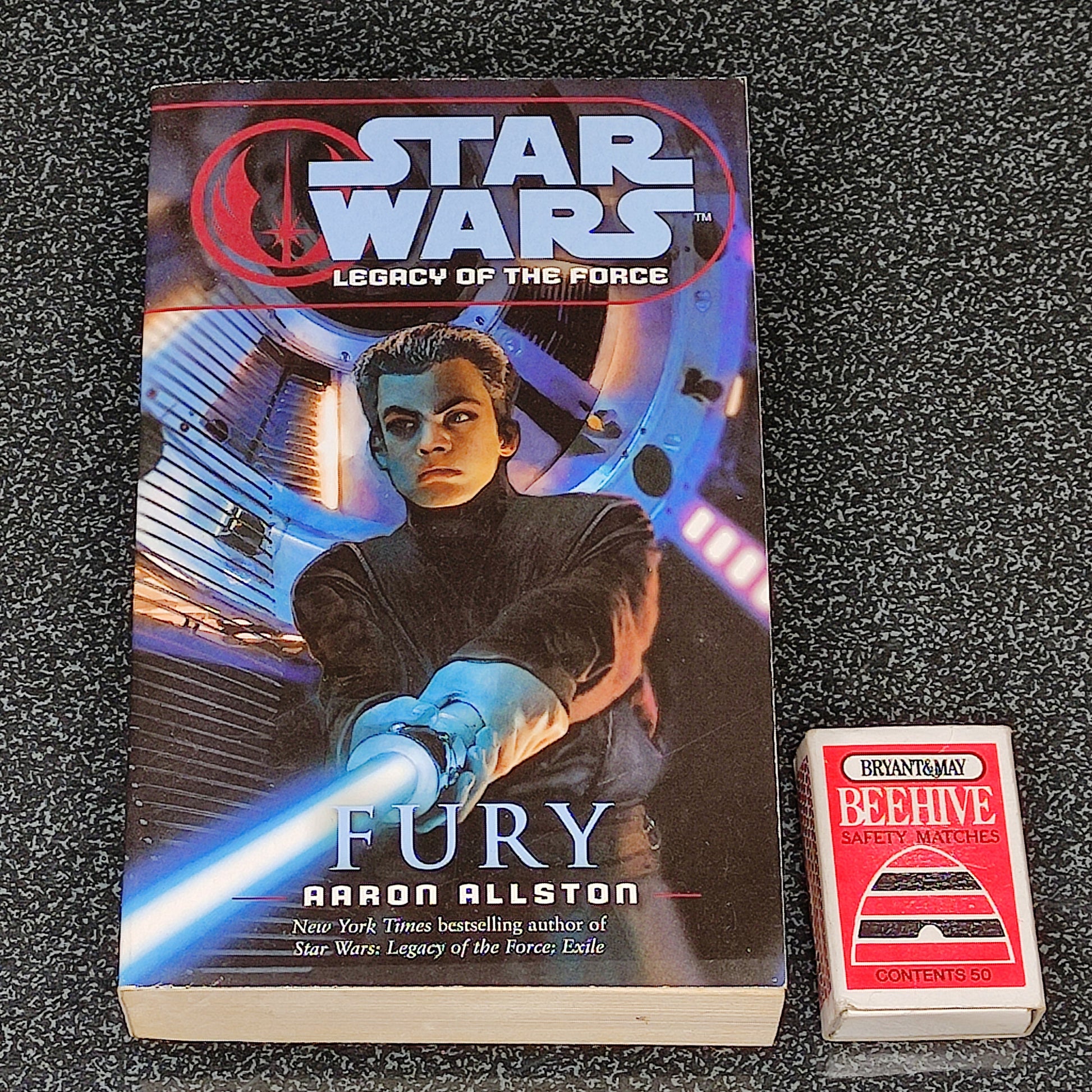 Book titled 'Star Wars: Legacy of the Force Fury' by Aaron Allston on a textured surface