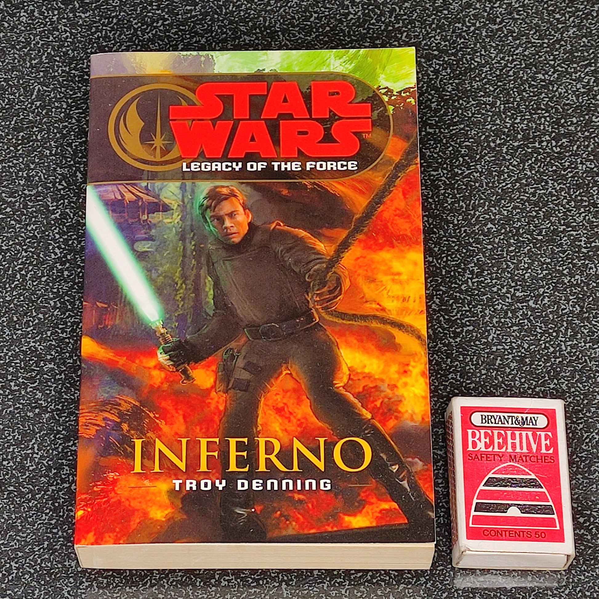Book titled 'Inferno' from 'Star Wars: Legacy of the Force' series on a dark textured background