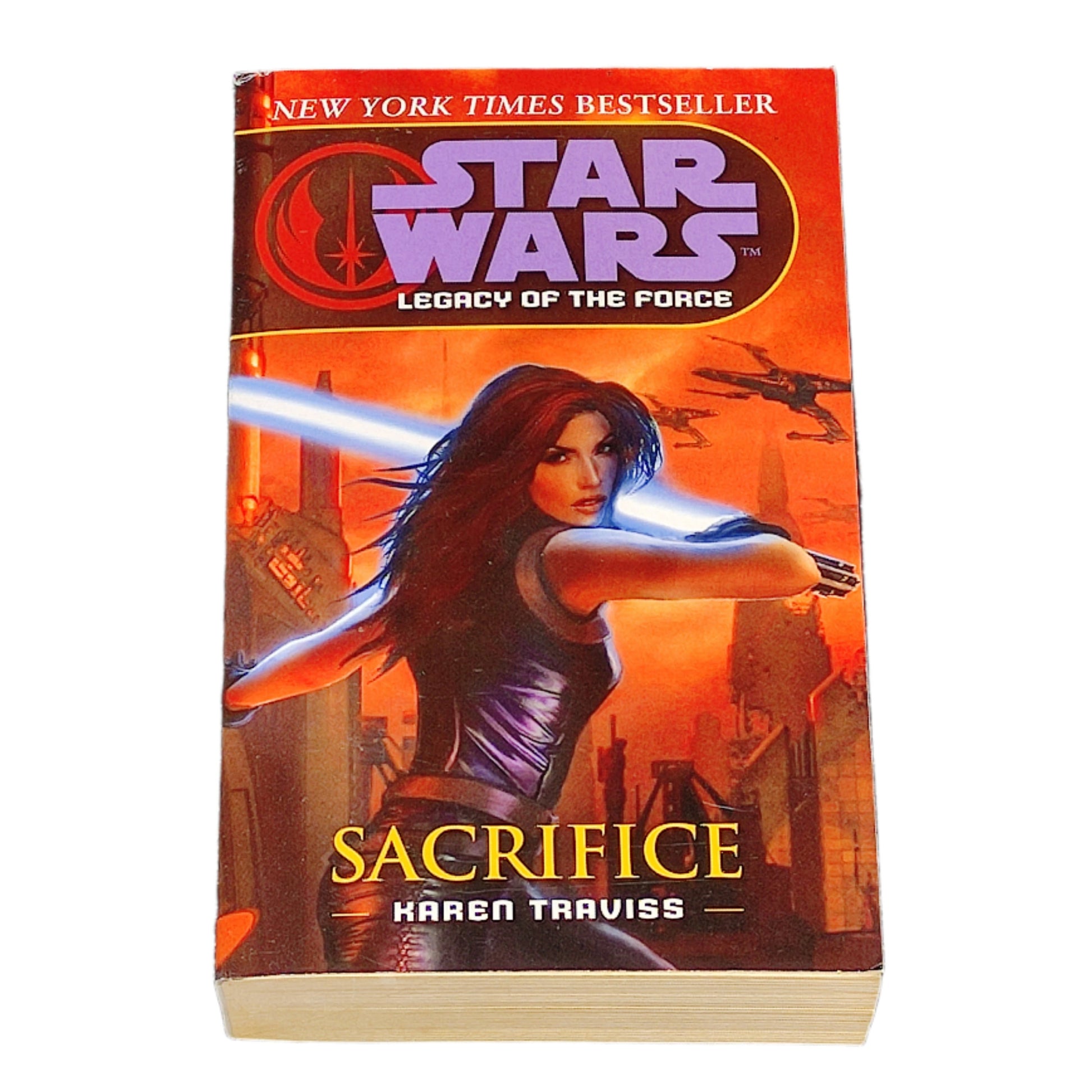 Book titled 'Sacrifice' by Karen Traviss from the Star Wars Legacy of the Force series on a white background