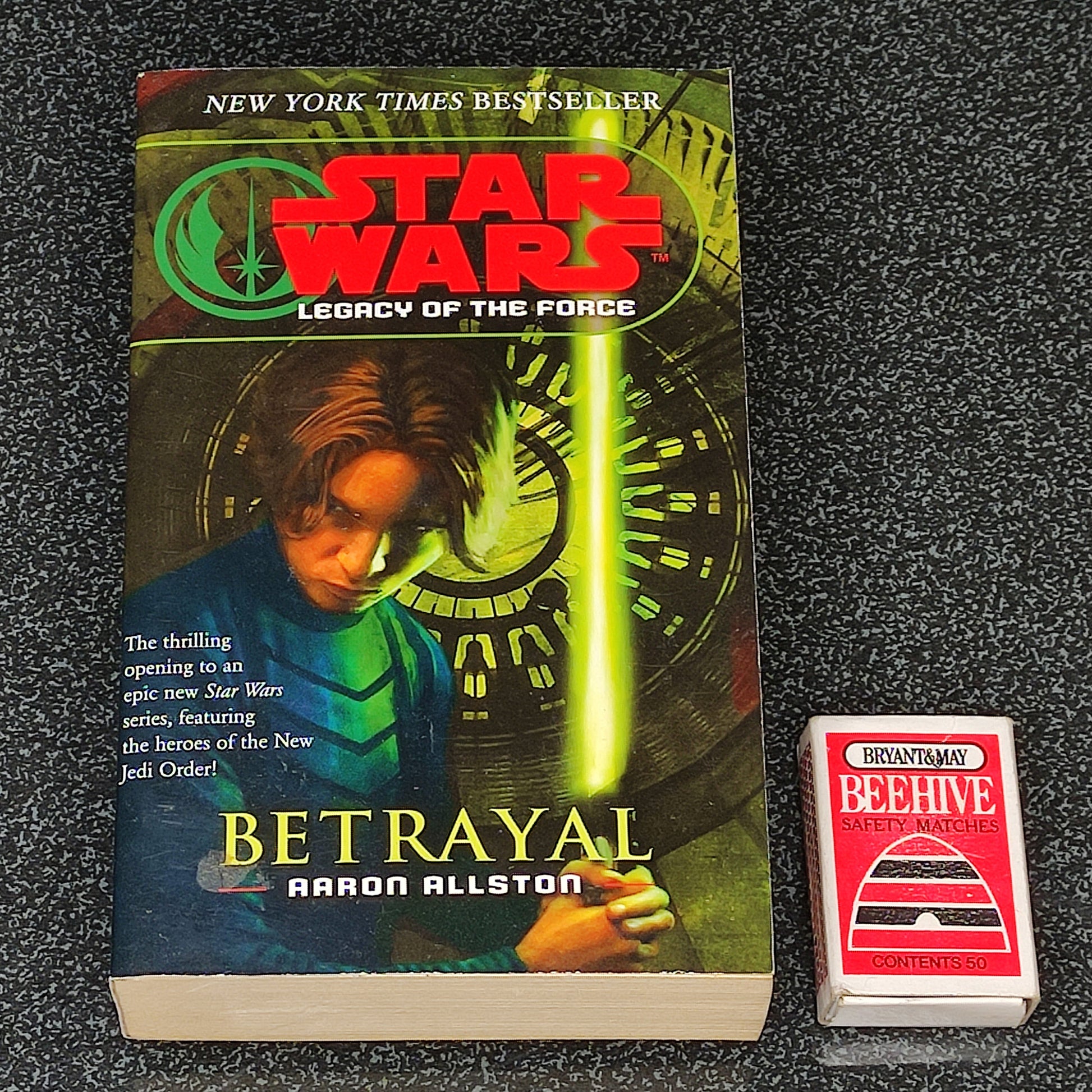 Book titled 'Betrayal' from 'Star Wars: Legacy of the Force' series on a dark textured surface
