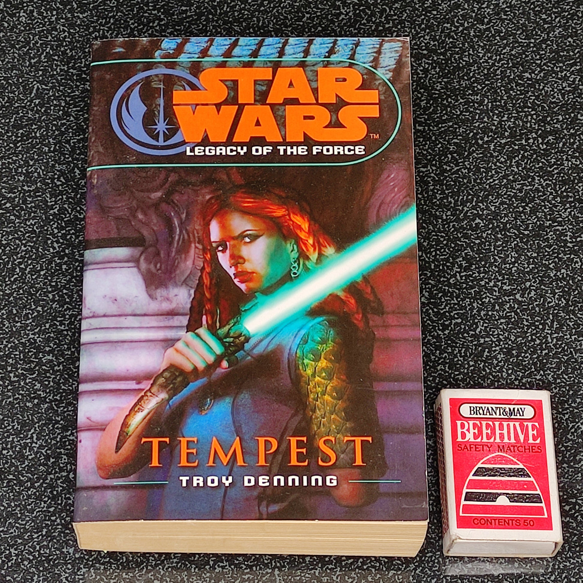 Book titled 'Tempest' from 'Star Wars: Legacy of the Force' series on a dark textured background