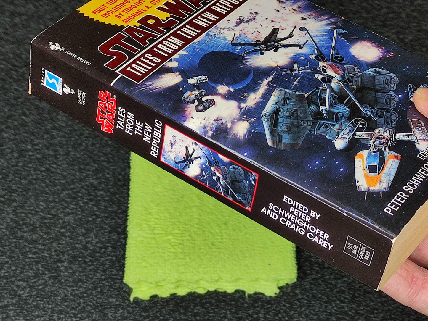 Book titled 'Star Wars: Tales from the New Republic' on a dark surface with a green cloth underneath.