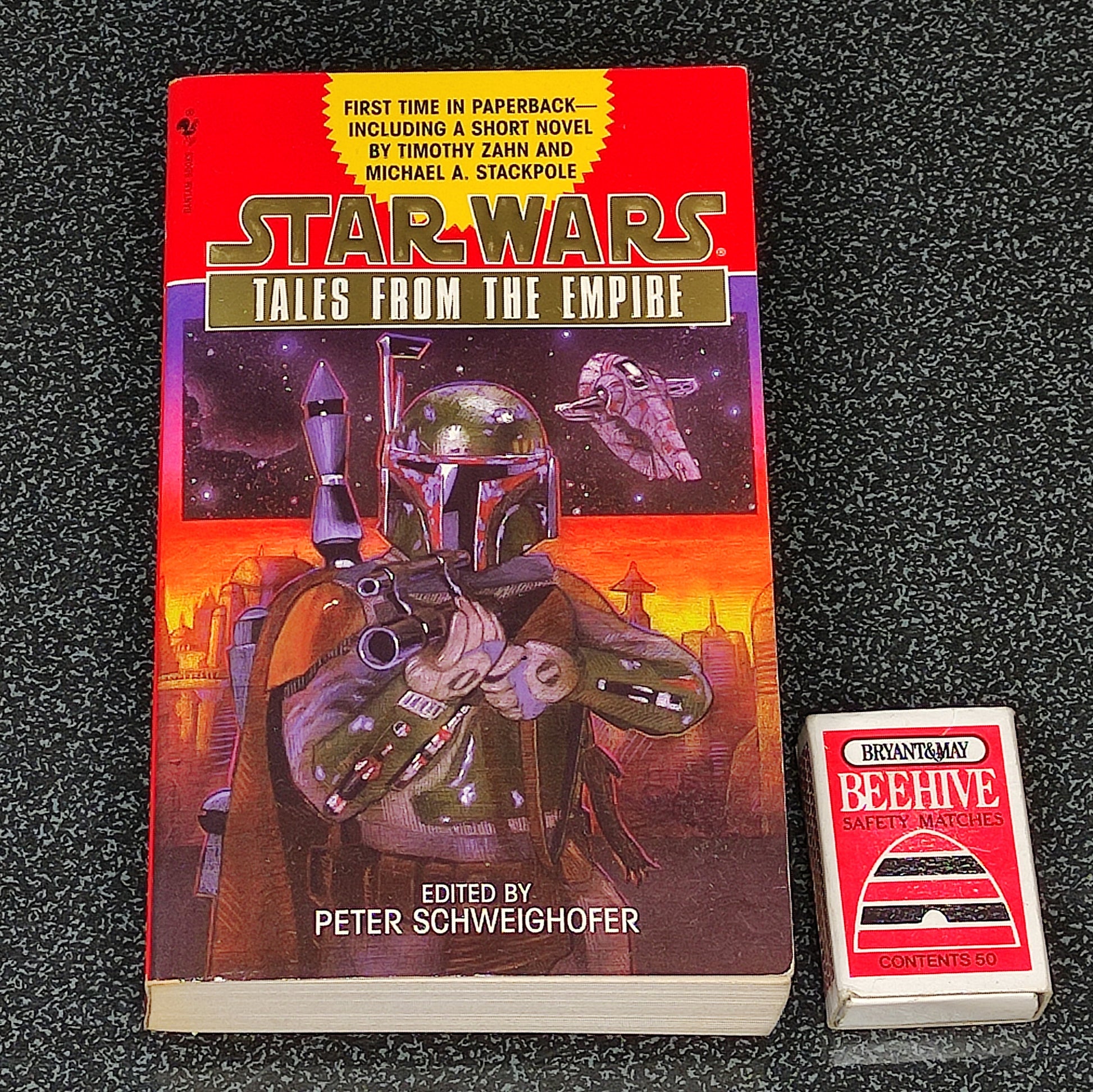 Book titled 'Star Wars: Tales from the Empire' with a Boba Fett figure on a dark textured background