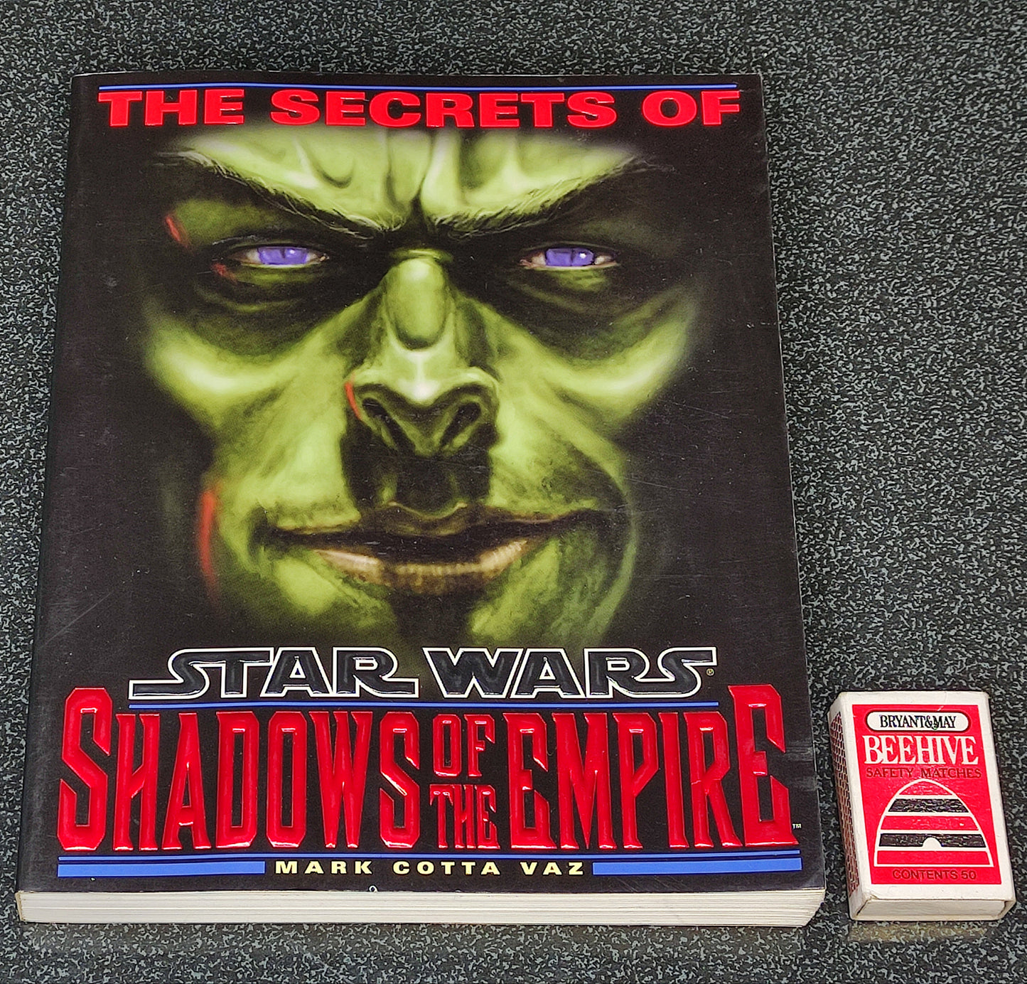 Book titled 'The Secrets of Star Wars: Shadows of the Empire' on a textured surface