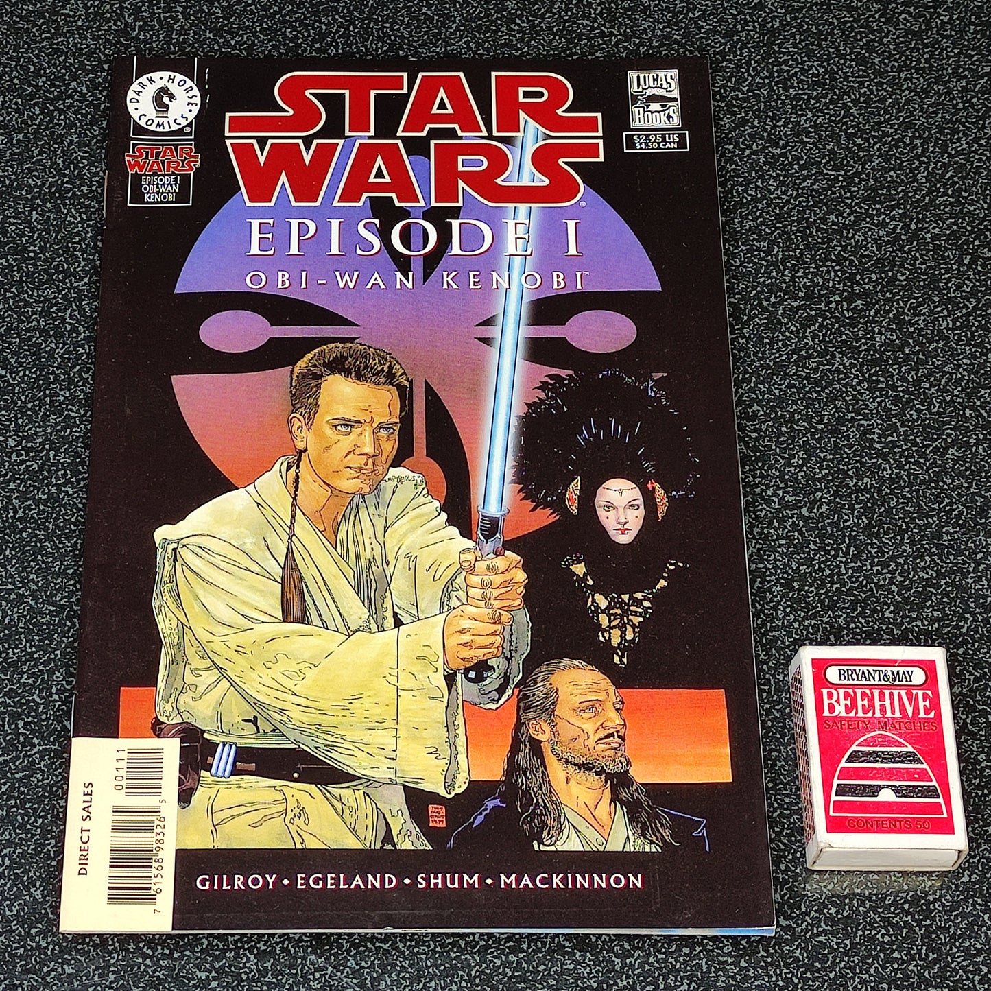 Star Wars Episode I comic book with a trading card on a textured surface