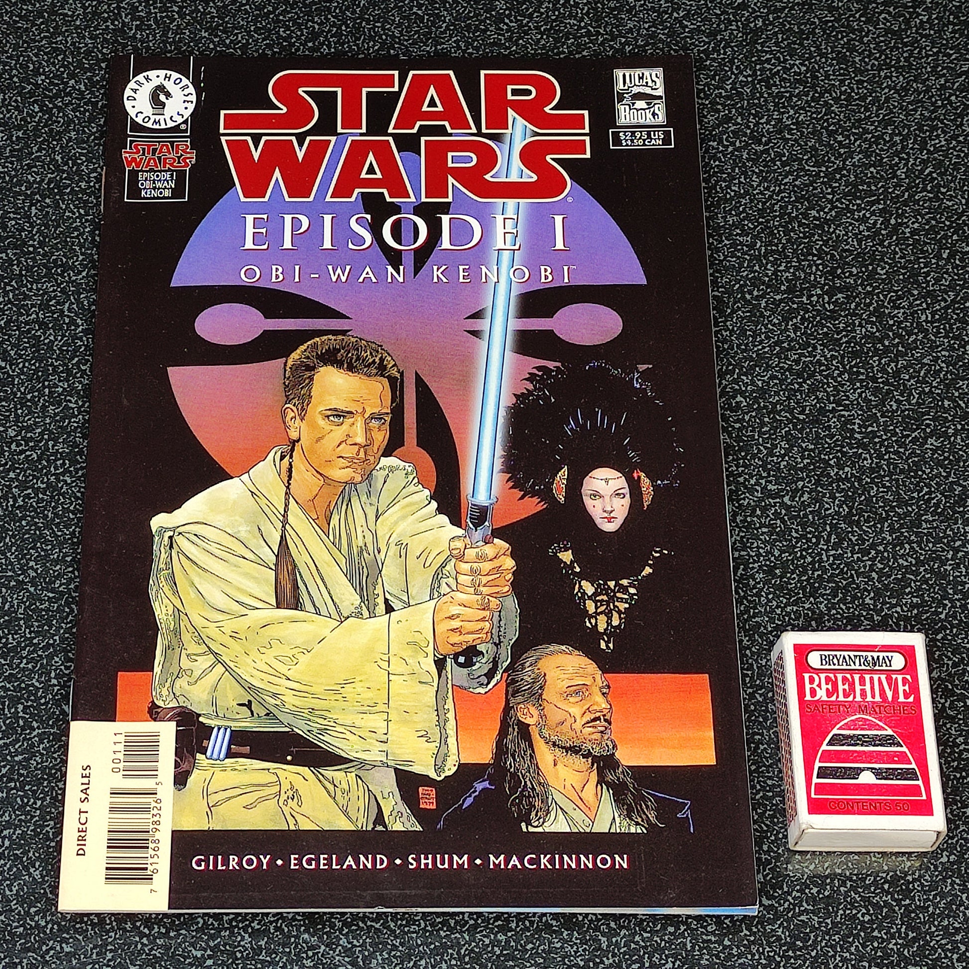 Star Wars Episode I comic book with a trading card on a textured surface
