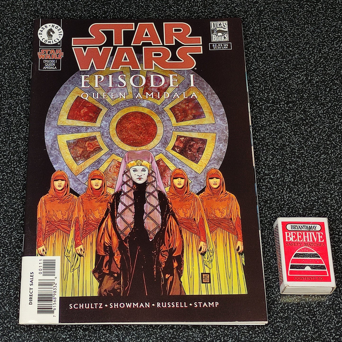 Star Wars comic book with cover art and a small box on a dark textured surface