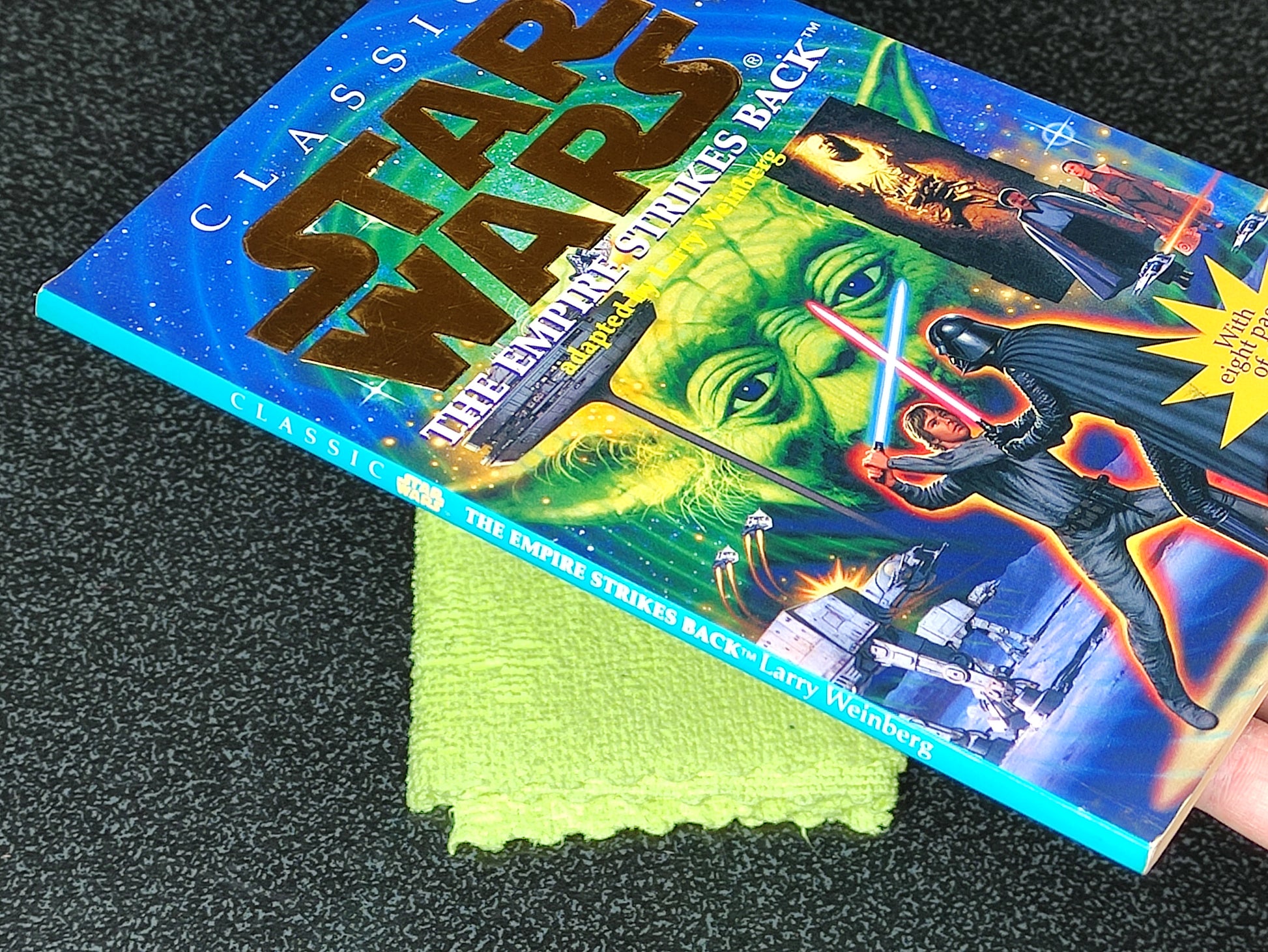 Star Wars trading card with a green cleaning cloth on a dark surface