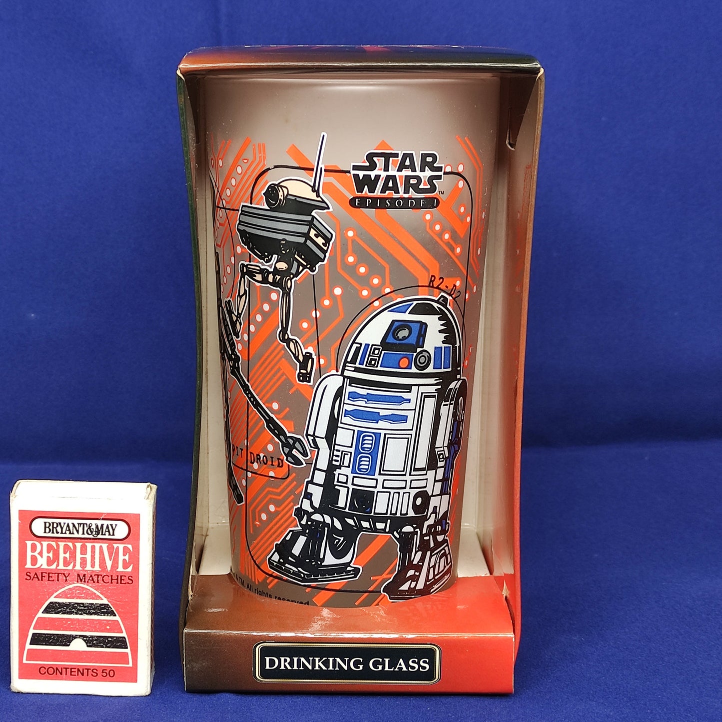 Star Wars-themed drinking glass with R2-D2 and droids design in packaging on a blue background
