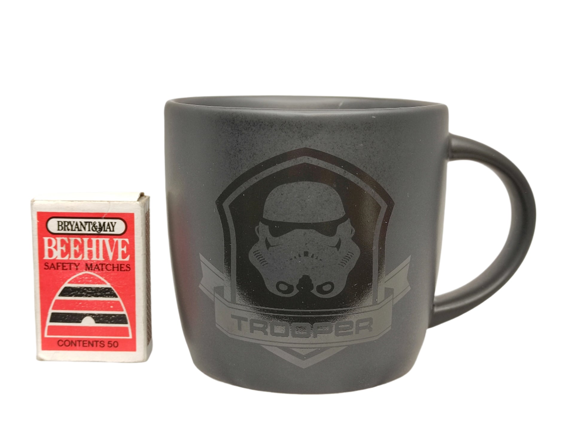 Black mug with 'Trooper' design on a white background