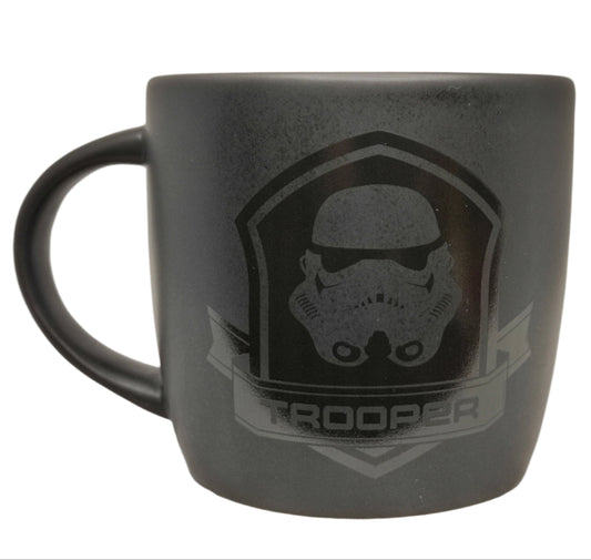 Black mug with 'Trooper' design on a white background