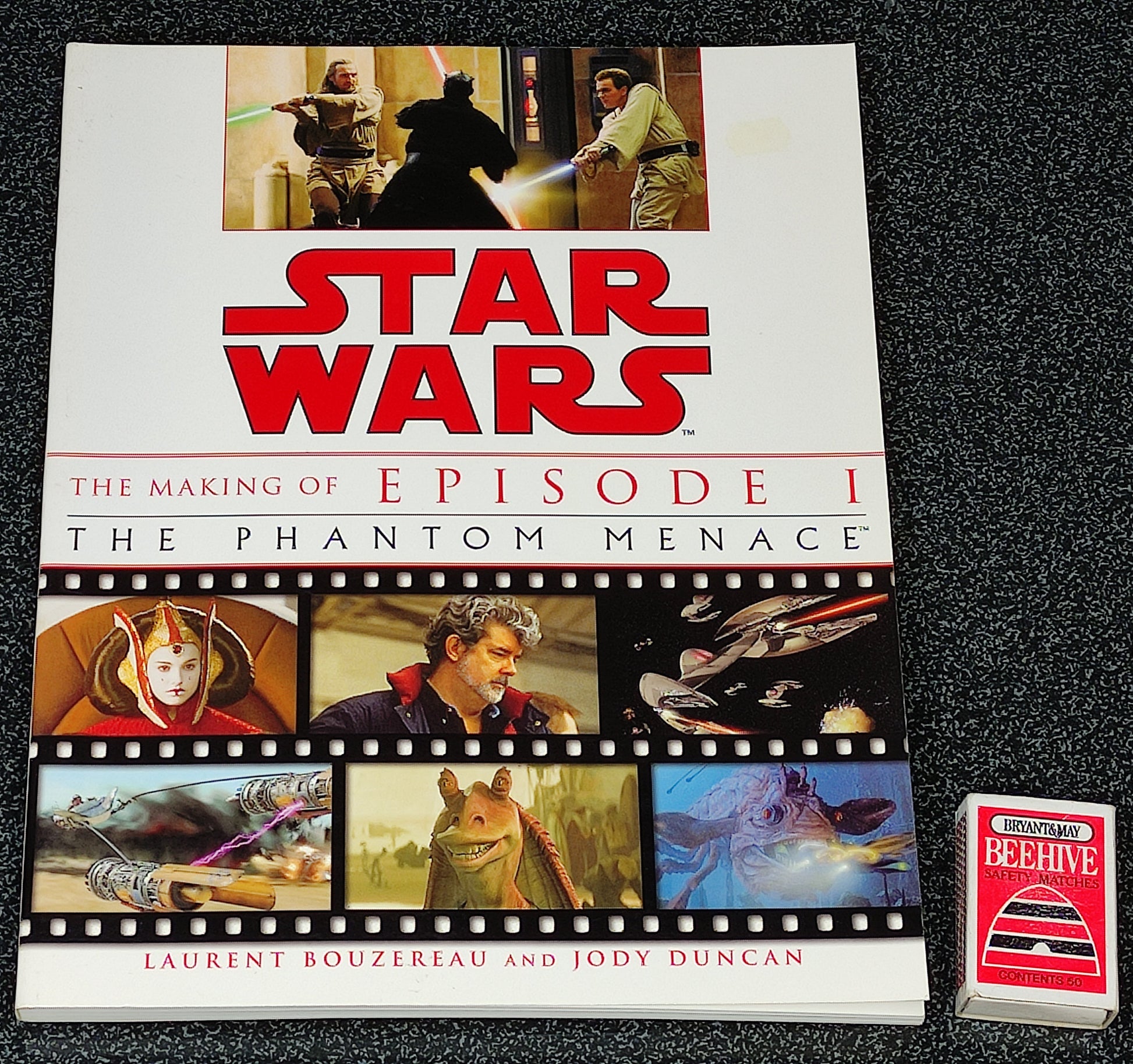 Book titled 'Star Wars: The Making of Episode I The Phantom Menace' on a dark textured surface.