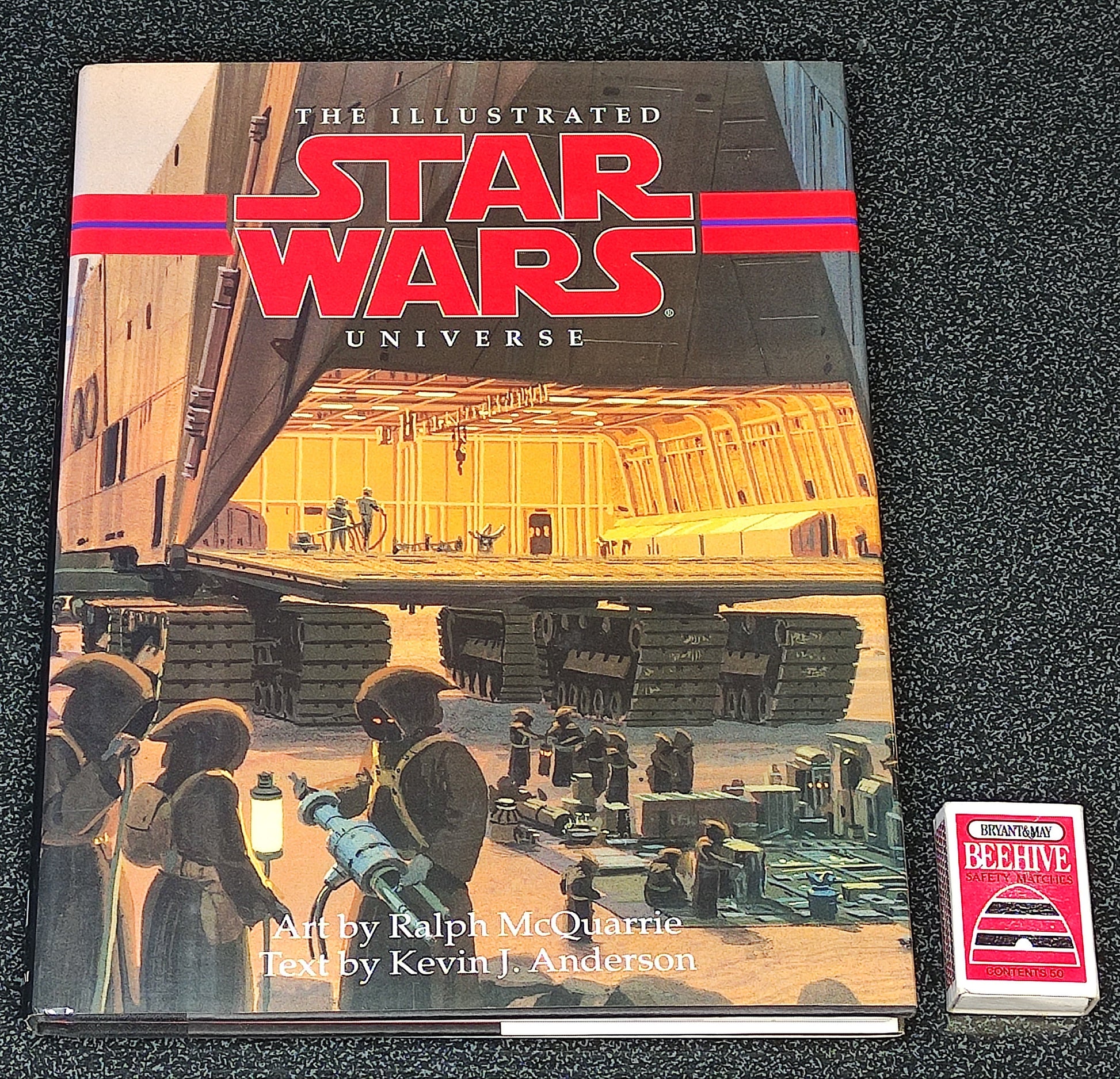 Book titled 'The Illustrated Star Wars Universe' on a dark textured surface