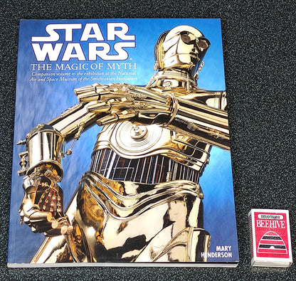 Book titled 'Star Wars: The Magic of Myth' with a gold robot on the cover, featuring a visible brand logo.