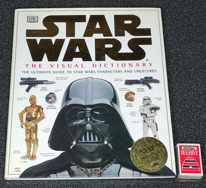 Star Wars book titled 'The Visual Dictionary' on a dark textured surface