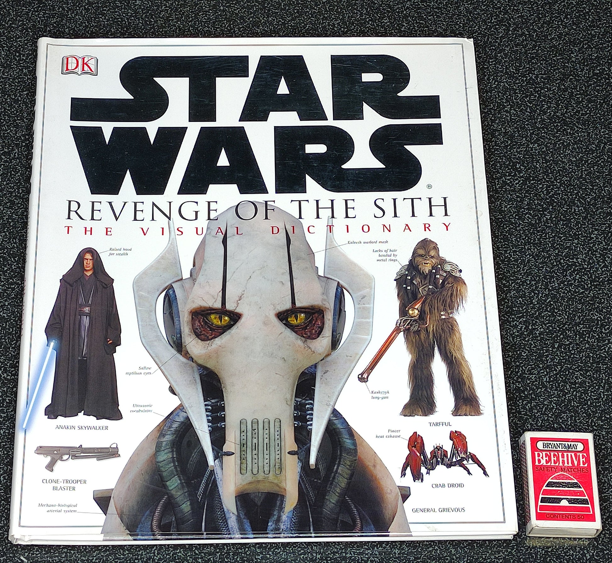 Star Wars book titled 'Revenge of the Sith: The Visual Dictionary' on a dark textured surface.