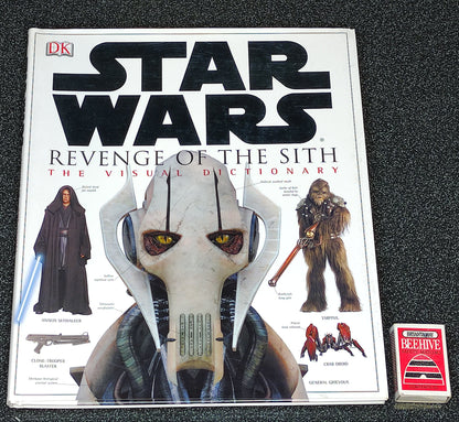 Star Wars book titled 'Revenge of the Sith: The Visual Dictionary' on a dark textured surface.