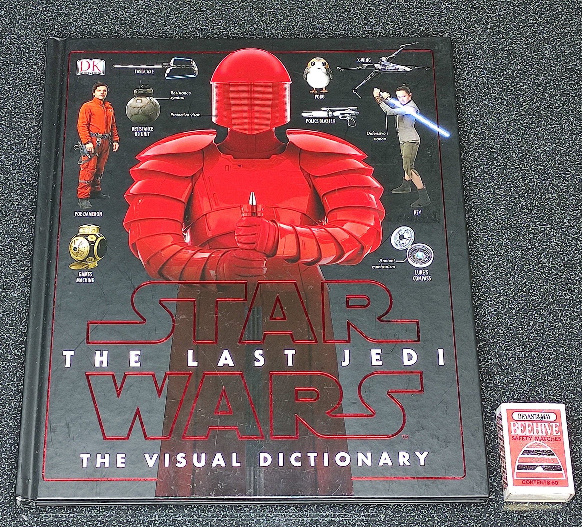 Star Wars book titled 'The Last Jedi: The Visual Dictionary' on a textured surface