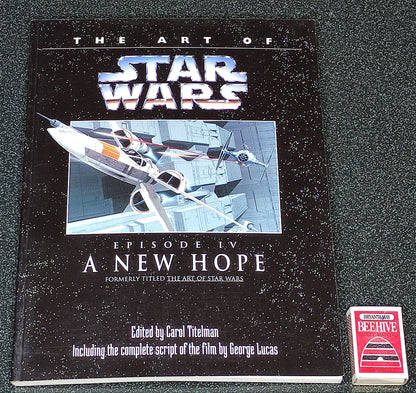 Book titled 'The Art of Star Wars Episode IV: A New Hope' on a gray background