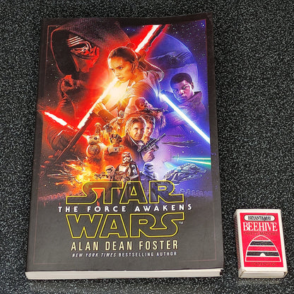 Book titled 'Star Wars: The Force Awakens' by Alan Dean Foster on a dark textured surface