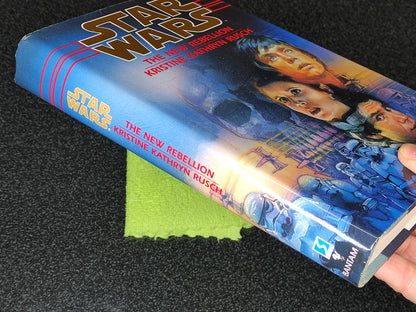 Book titled 'Star Wars: The New Rebellion' by Kristine Kathryn Rusch held against a dark background.