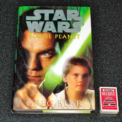 Book titled 'Star Wars: Rogue Planet' by Greg Bear on a textured black surface
