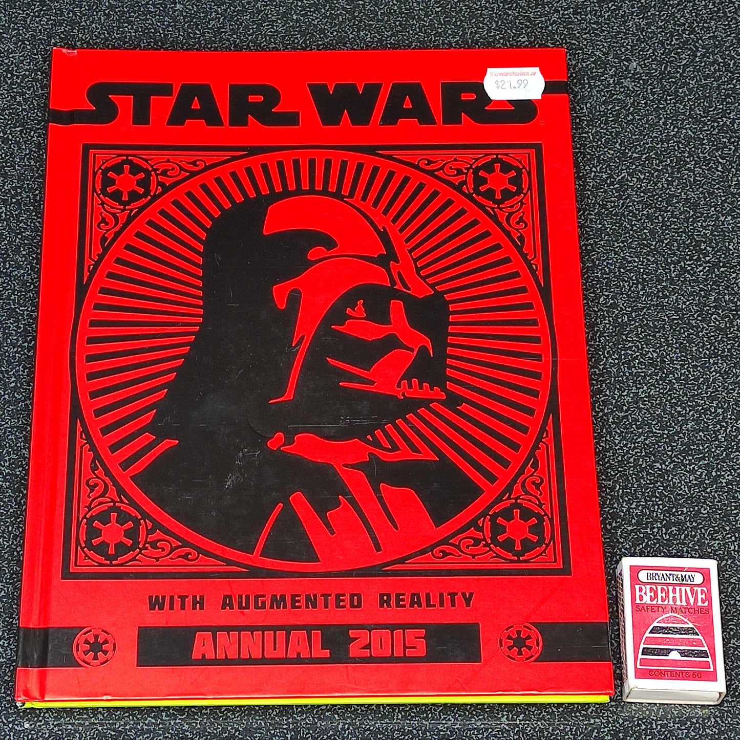 Star Wars annual book with Darth Vader silhouette on a red cover, placed on a textured surface.