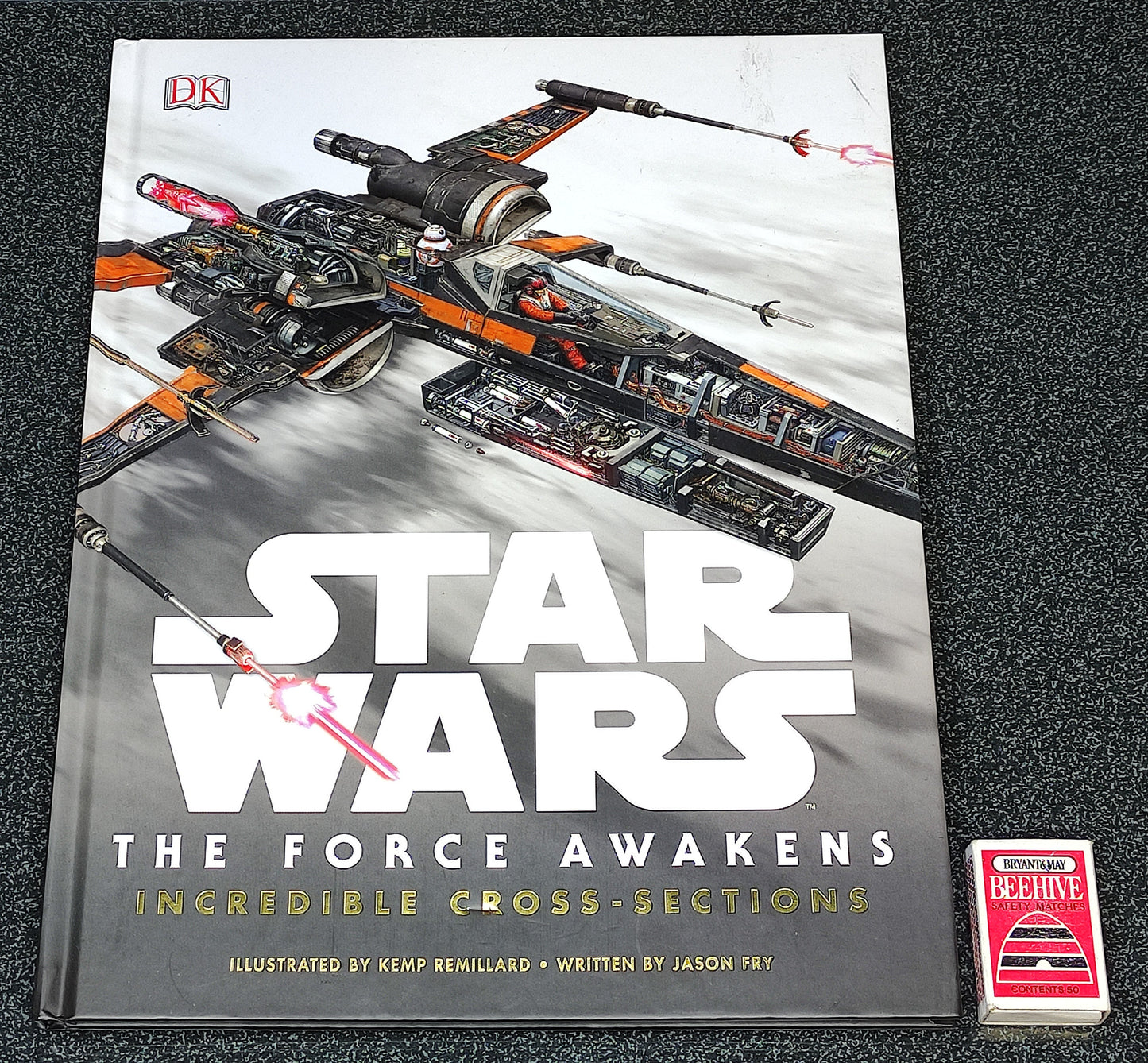 Book titled 'Star Wars: The Force Awakens' with a spaceship illustration on a dark textured background
