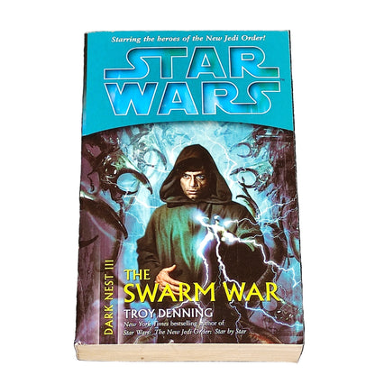 Book titled 'The Swarm War' by Troy Denning with Star Wars branding on a textured surface.