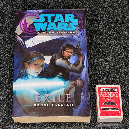 Book titled 'Exile' by Aaron Allston from the Star Wars Legacy of the Force series on a dark textured surface.