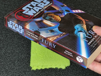 Book titled 'Fury' from 'Star Wars: Legacy of the Force' series on a dark surface with a green cloth.