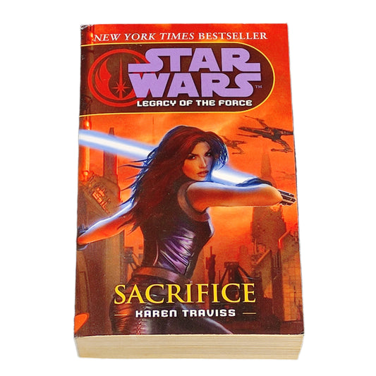 Book titled 'Sacrifice' by Karen Traviss from the Star Wars Legacy of the Force series on a white background