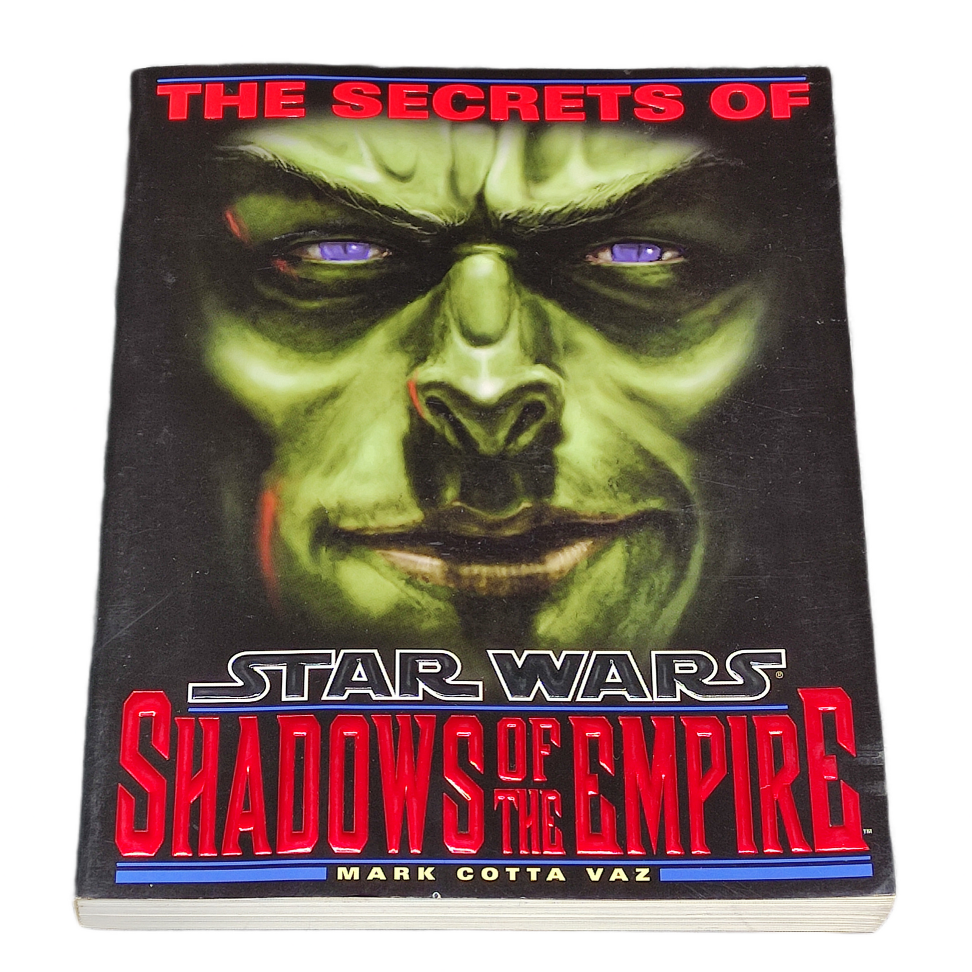 Book cover of 'The Secrets of Shadows of the Empire' featuring a creature's face with red and blue accents.
