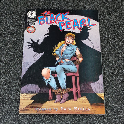 Comic book cover titled 'The Black Pearl' featuring a character on a stool with a dark silhouette in the background.