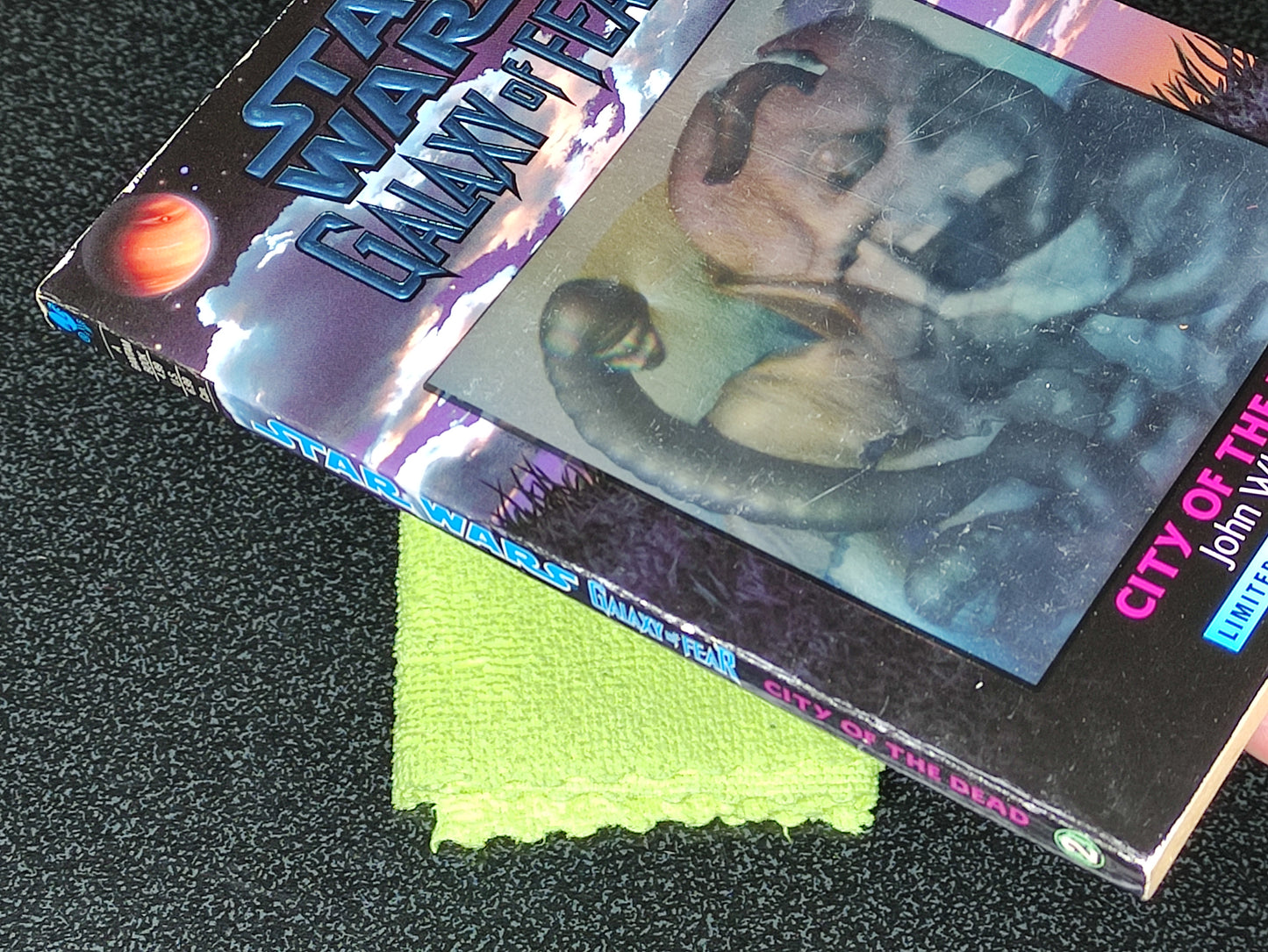 Two books titled 'Star Wars Galaxy of Hope' and 'City of the Dead' on a textured surface with a green cloth underneath.