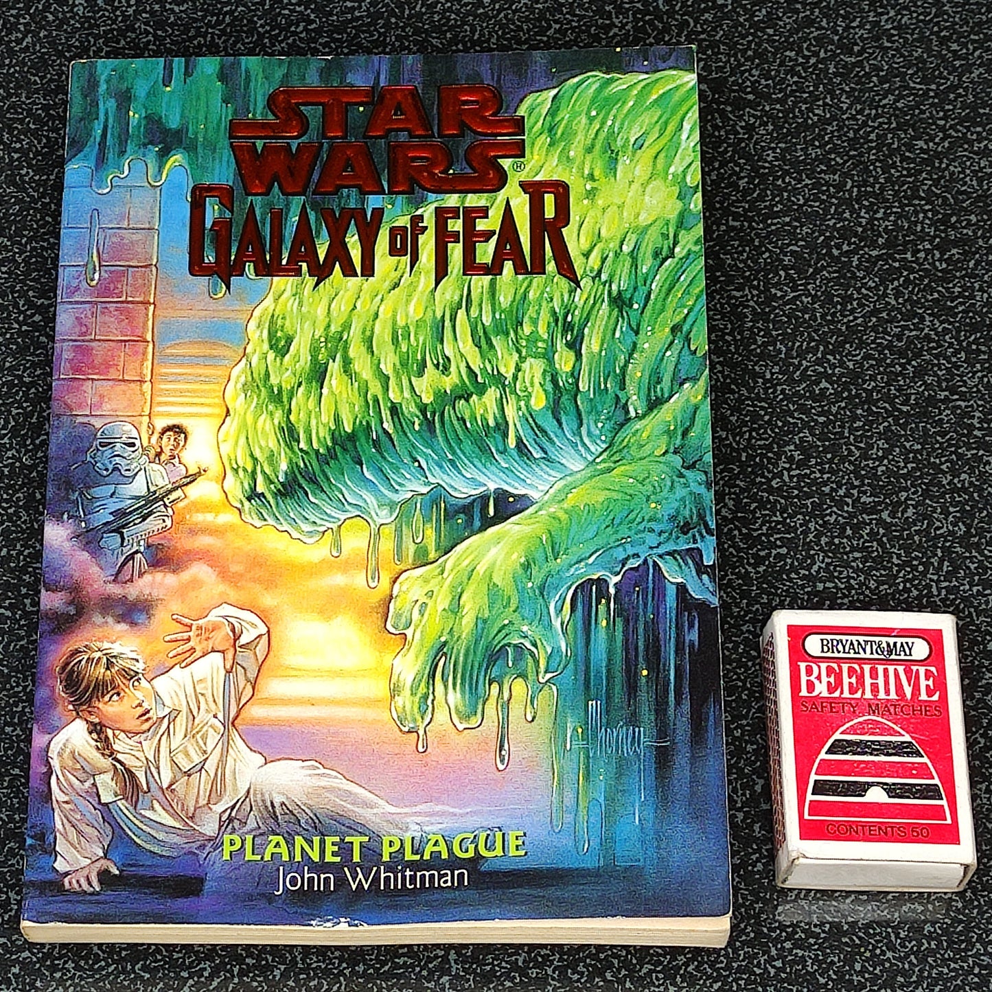 Book titled 'Star Wars: Galaxy of Fear Planet Plague' by John Whitman on a black textured background