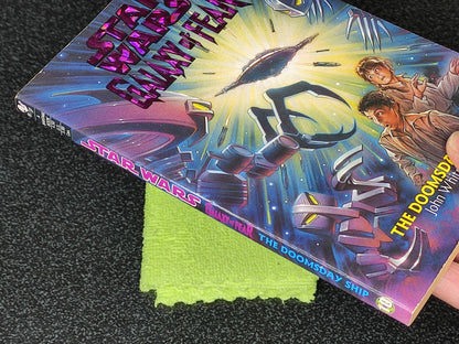 Star Wars book titled 'The Doomsday Ship' on a textured surface with a green cloth underneath.