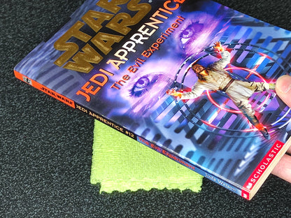 Star Wars Jedi Apprentice book with a toy figure on a dark surface