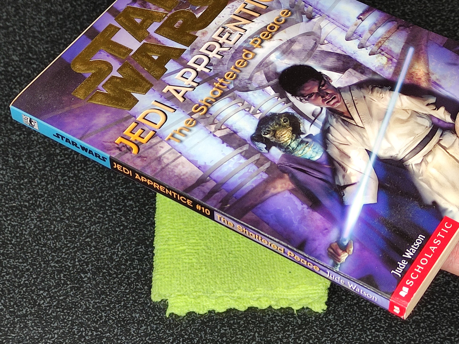 Star Wars Jedi Apprentice book on a textured surface with a green cloth underneath
